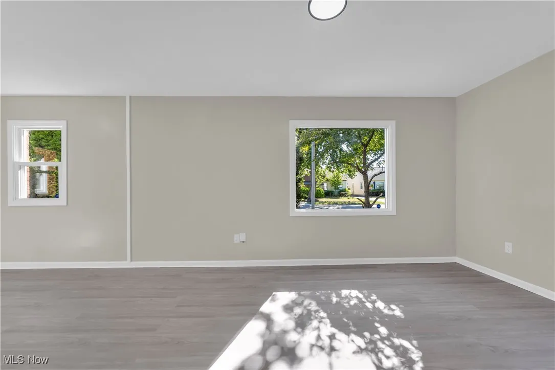 Spare room with wood finished floors and plenty of natural light