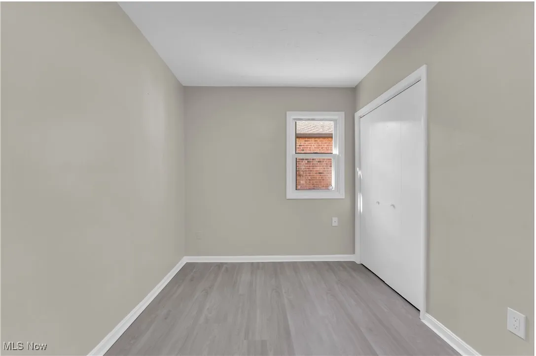 Unfurnished room featuring baseboards and light wood finished floors