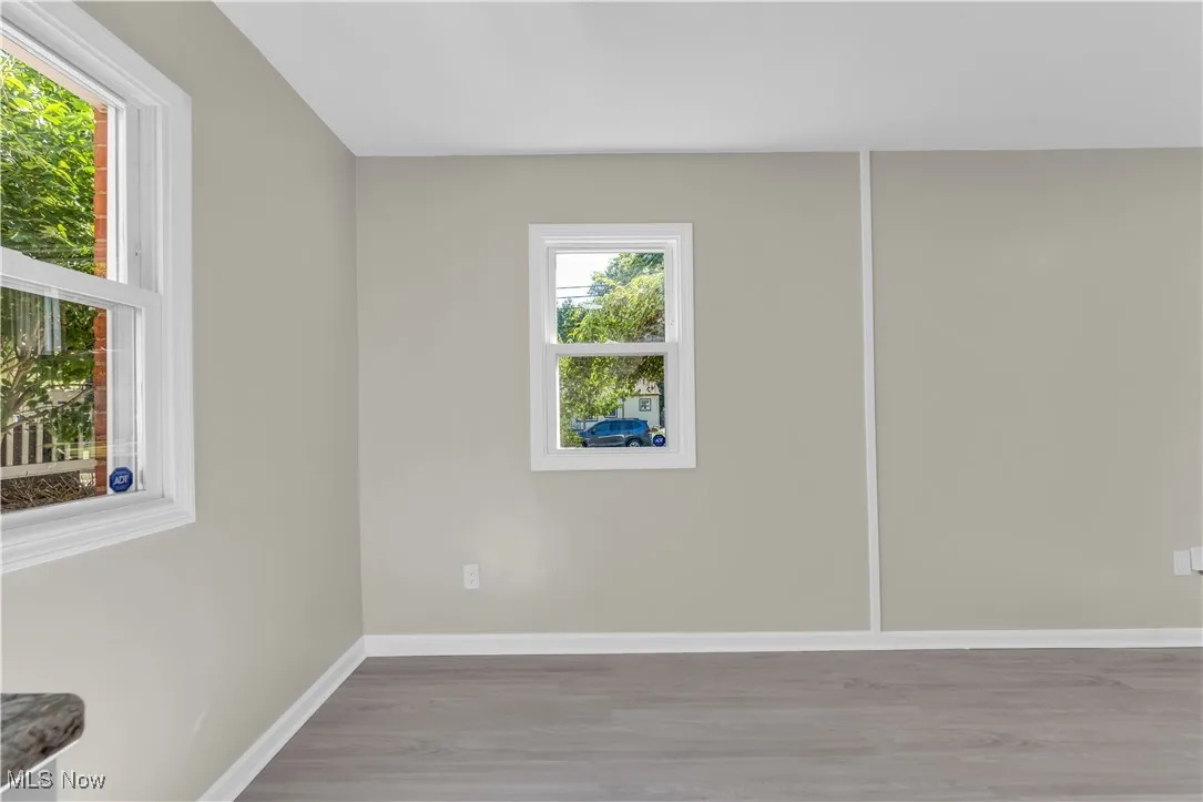 Empty room with light wood finished floors and baseboards