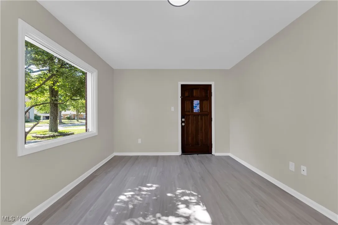 Foyer with light wood-type flooring and baseboards