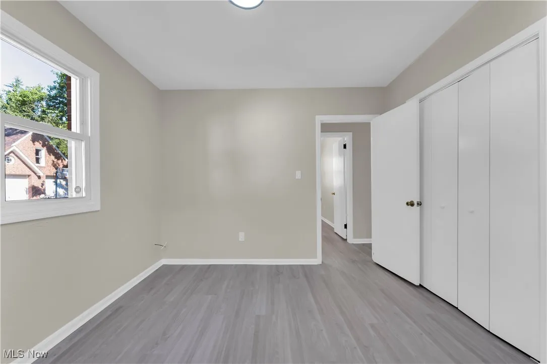 Unfurnished bedroom with light wood-type flooring and a closet