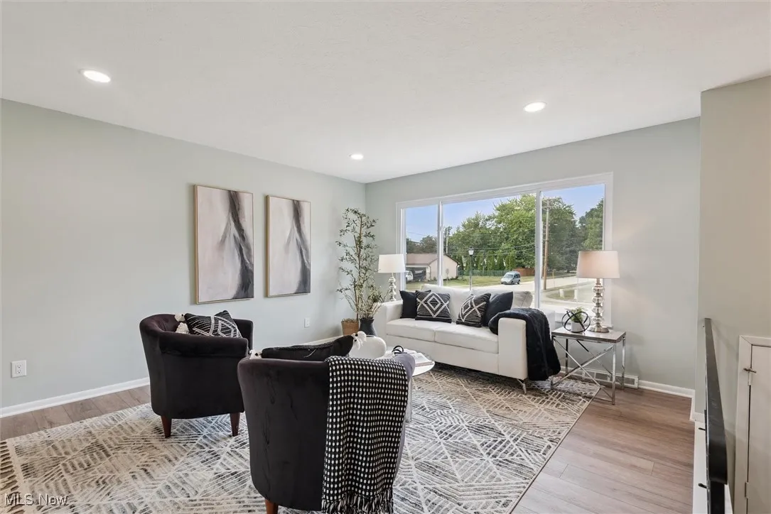 Living room featuring light wood-type flooring and recessed lighting