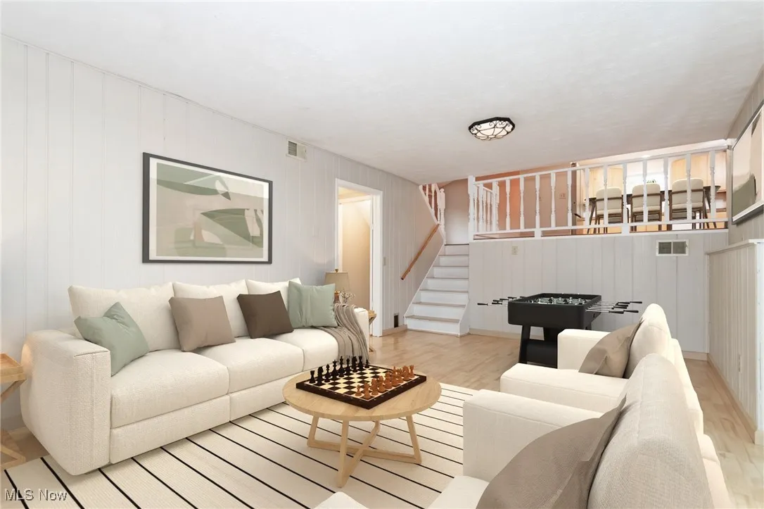 Living area with wood finished floors and stairs
