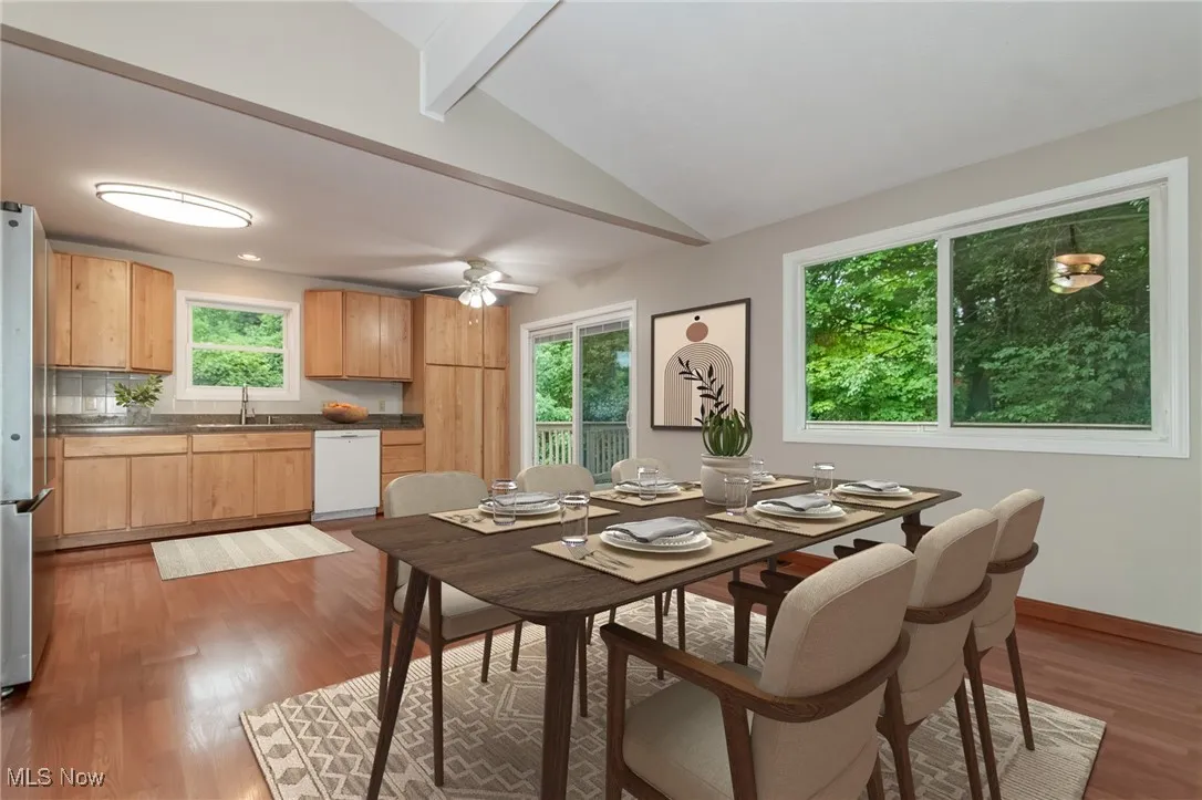 Dining room with light wood finished floors and a ceiling fan