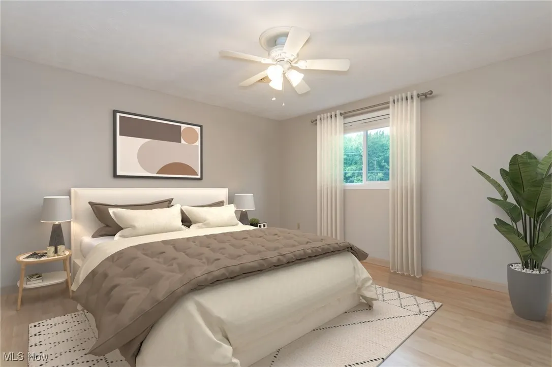 Bedroom with light wood finished floors and ceiling fan