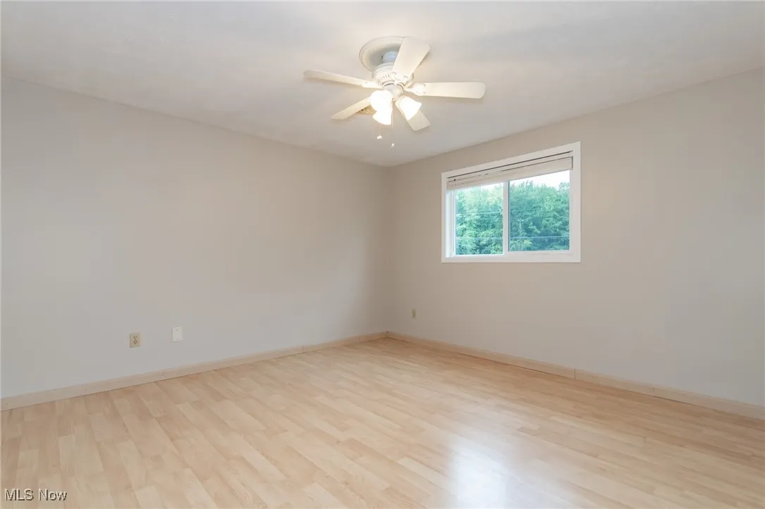Unfurnished room with light wood-style floors and a ceiling fan