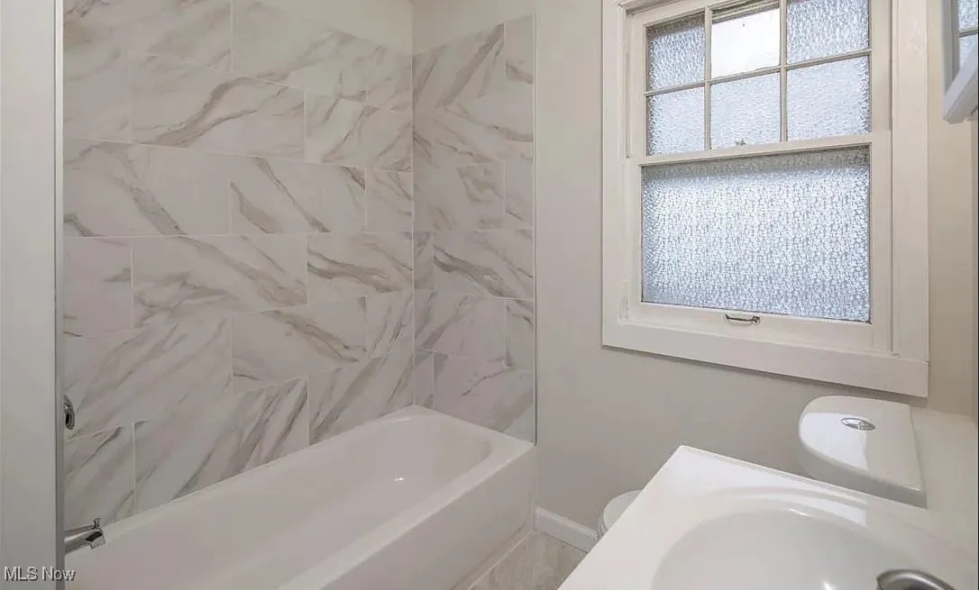 Full bathroom featuring shower / tub combination and vanity