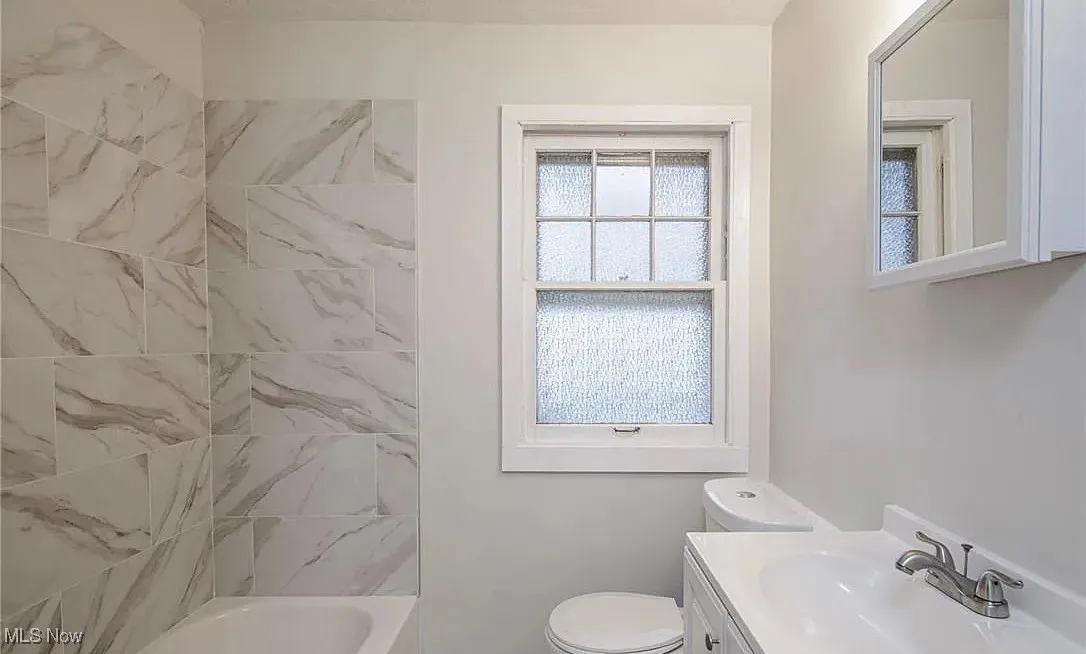 Bathroom with vanity and shower / bath combination