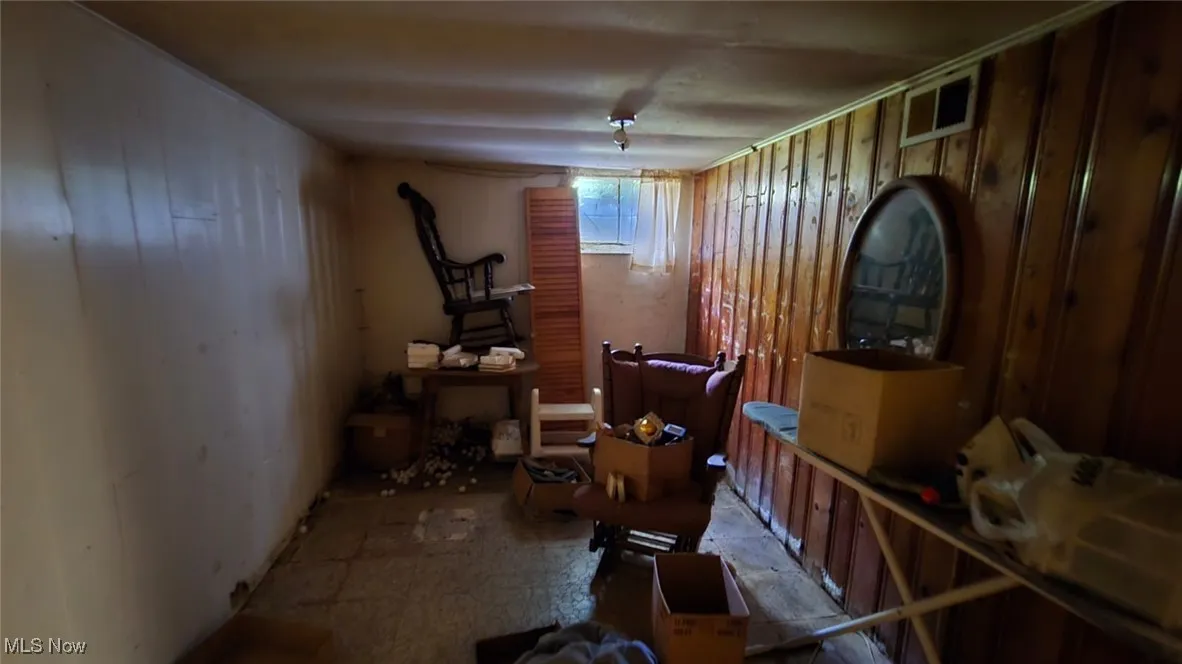 Miscellaneous room featuring wood walls