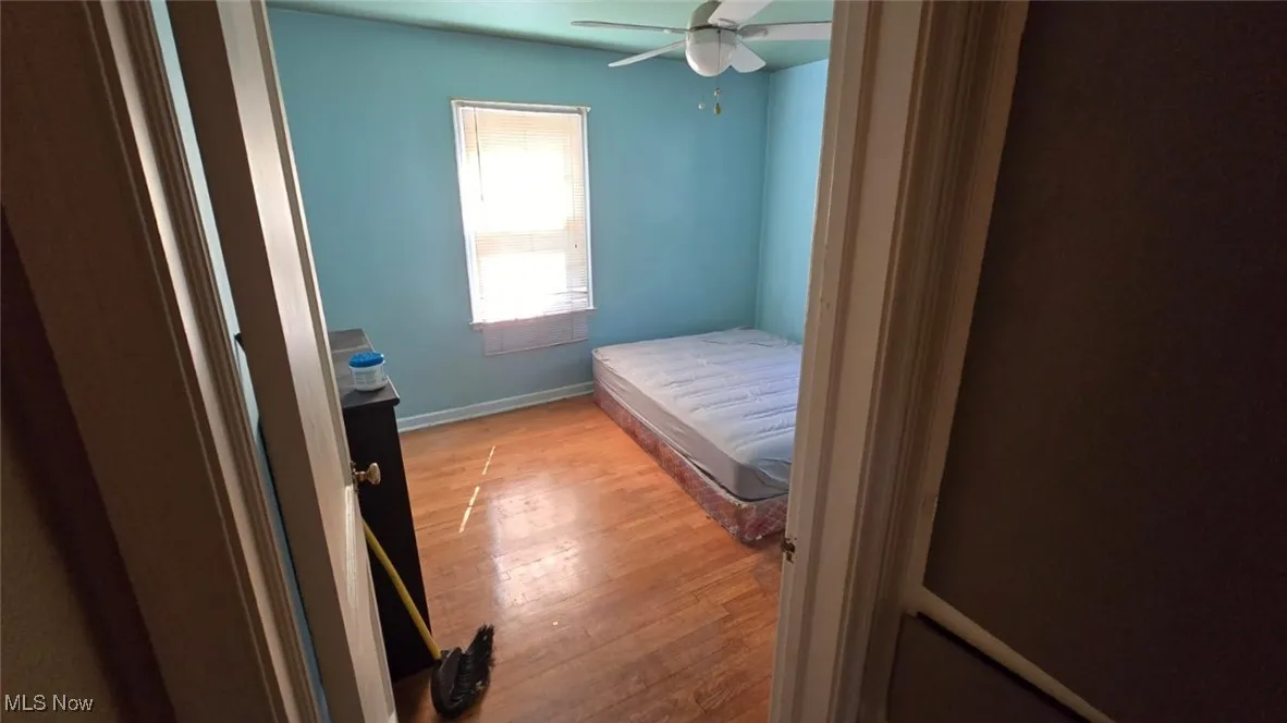 Bedroom featuring wood finished floors and ceiling fan