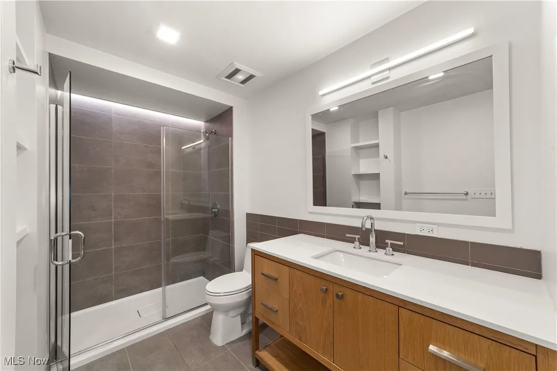 Large bathroom with sleek finishes and lots of countertop space

