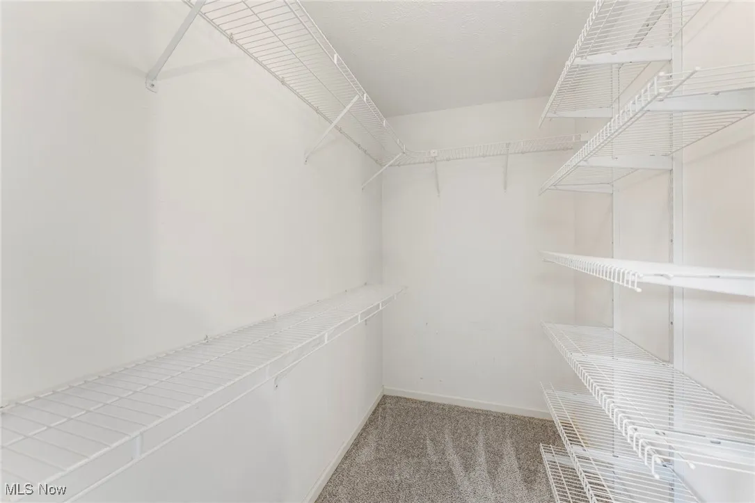 Primary bedroom walk-in closet