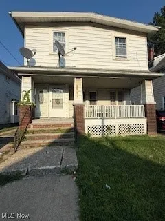 View of front of house with a front lawn and covered porch