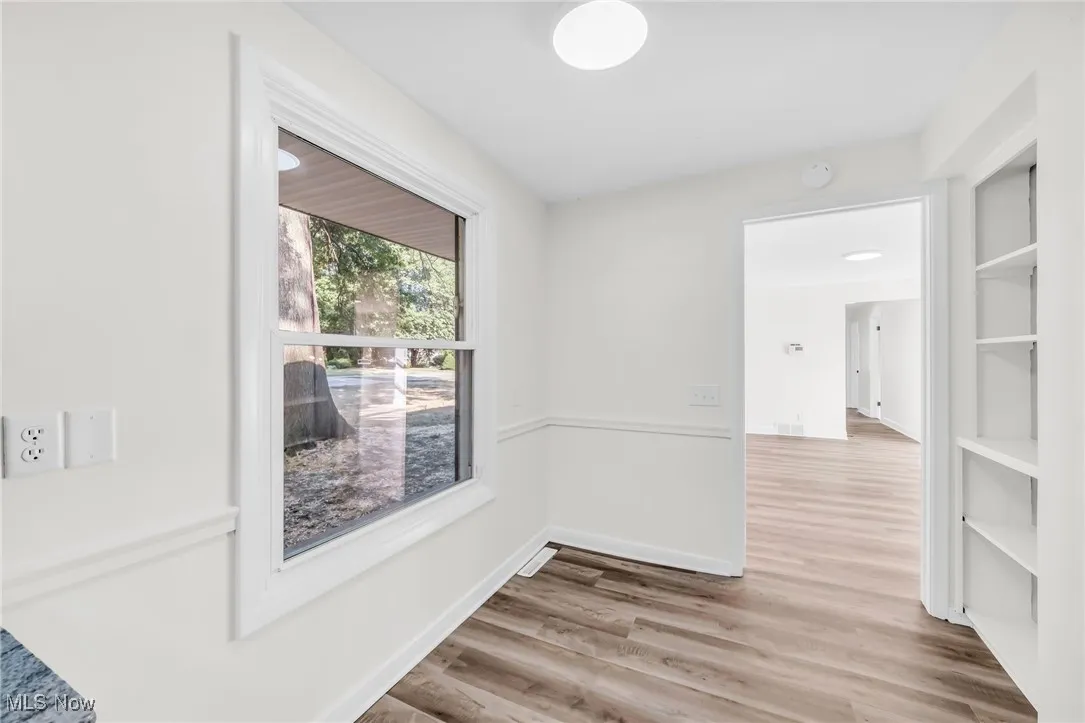Unfurnished room with light wood-style floors and baseboards