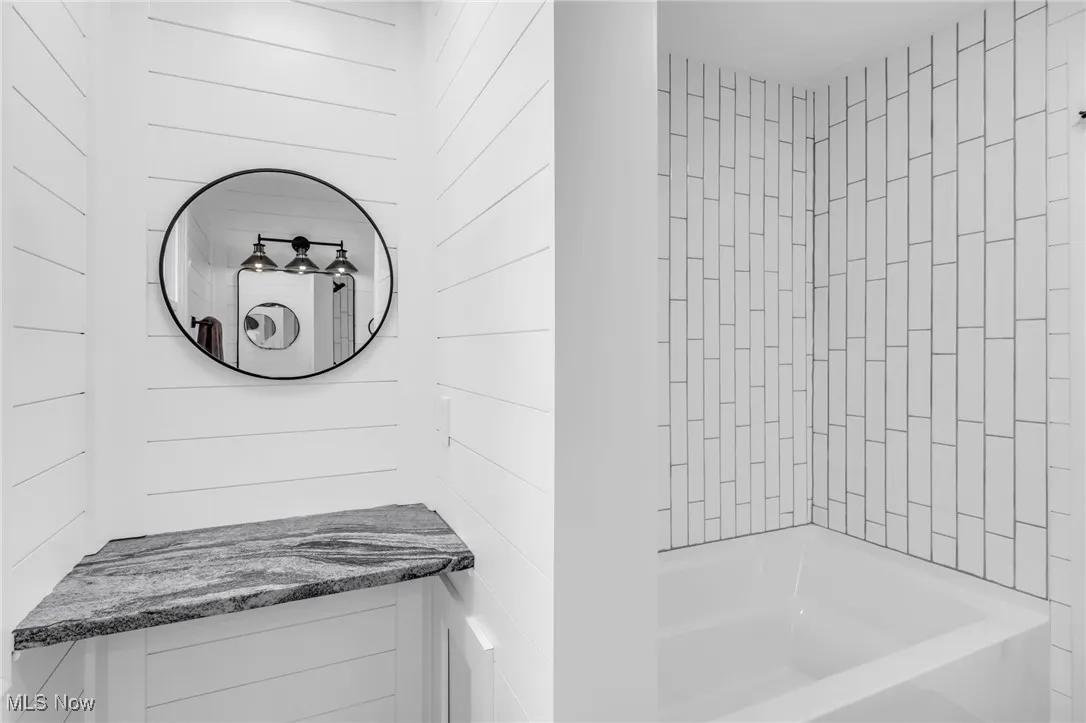 Full bath with shower / washtub combination and vanity