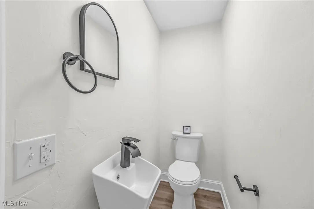 Bathroom with wood finished floors and toilet