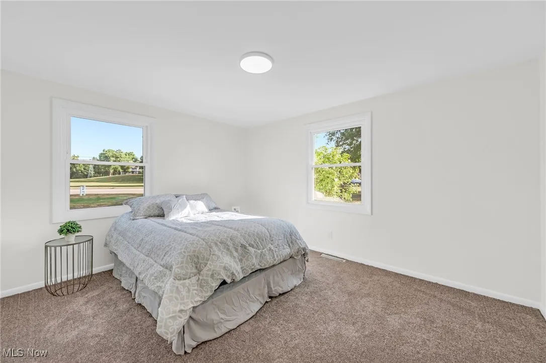 Bedroom with carpet and baseboards