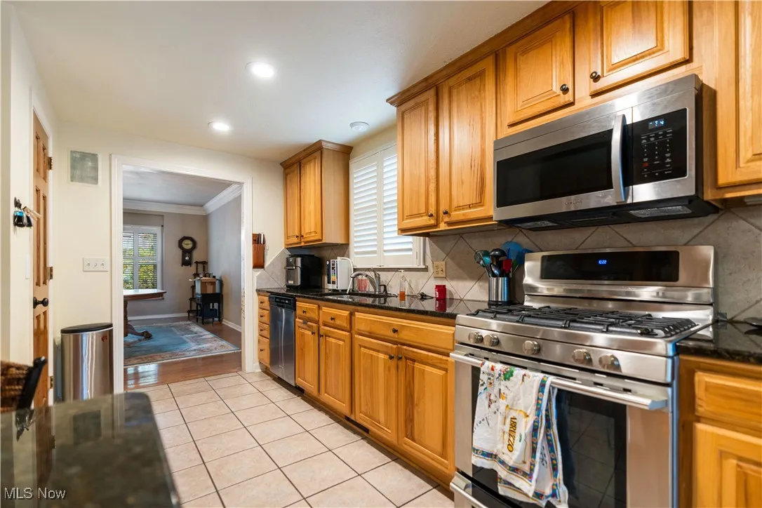 Lots of cabinet space and a backsplash in the kitchen.