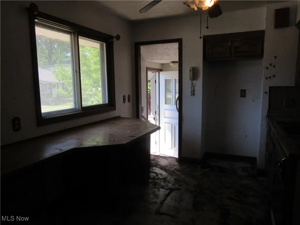 Kitchen with plenty of natural light and a ceiling fan