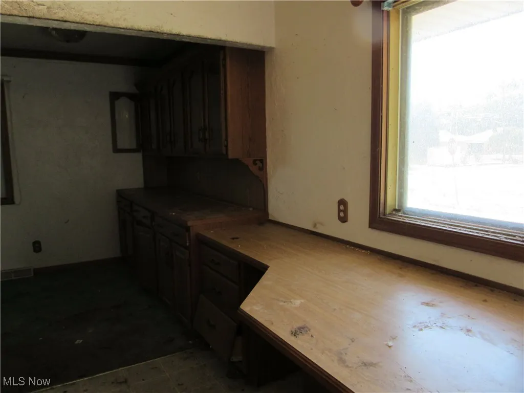 Kitchen featuring baseboards and light countertops