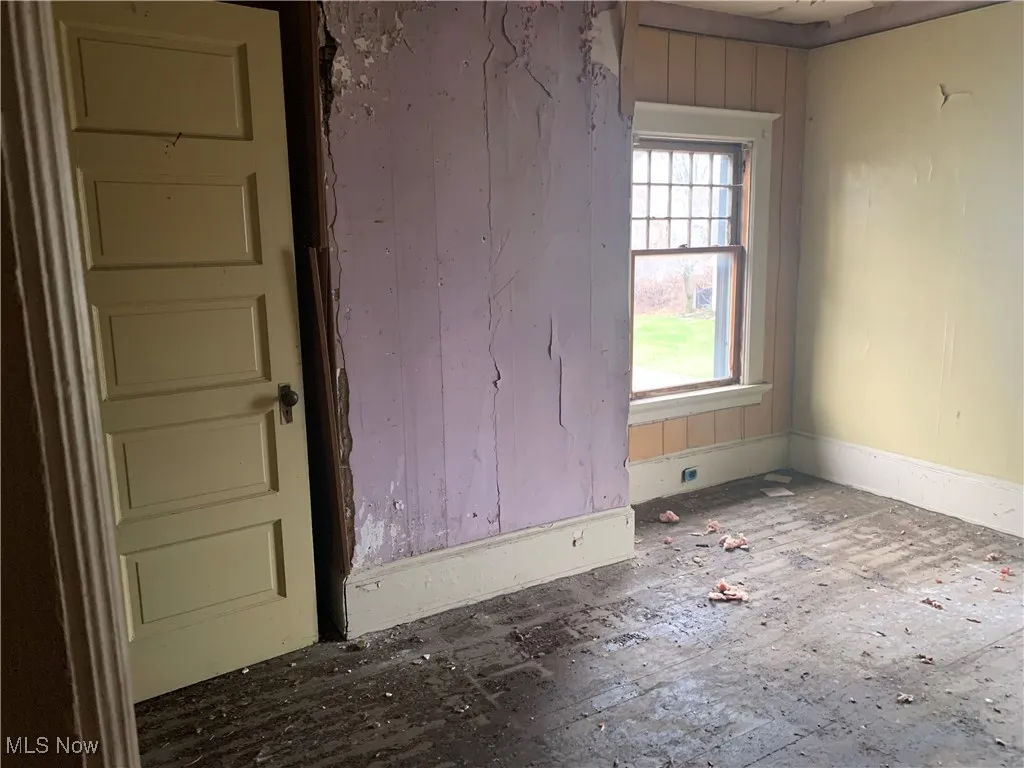 Spare room with wood walls