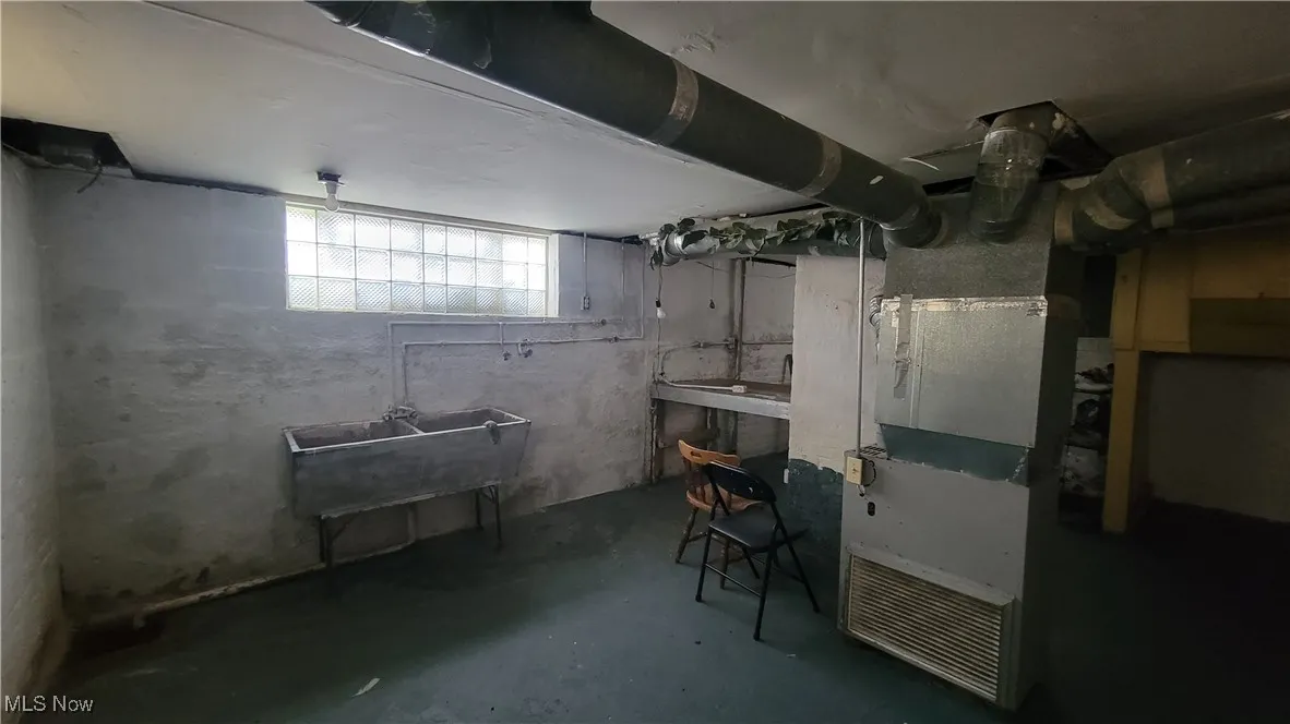 Basement with heating unit and a sink