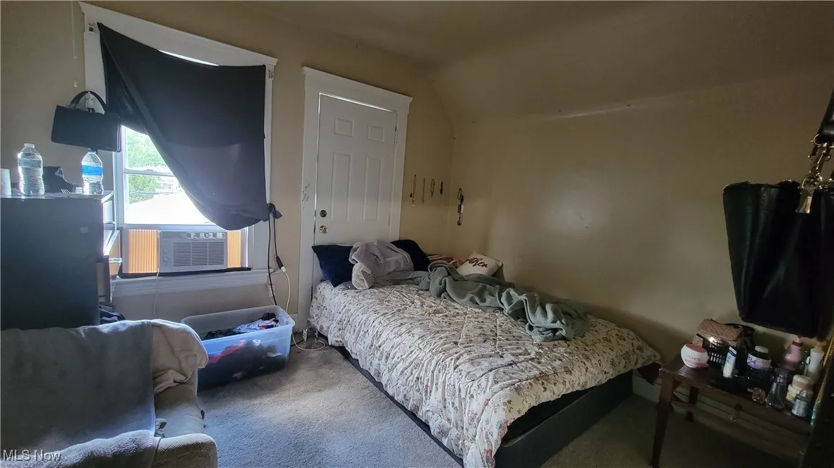 Bedroom featuring carpet floors and lofted ceiling