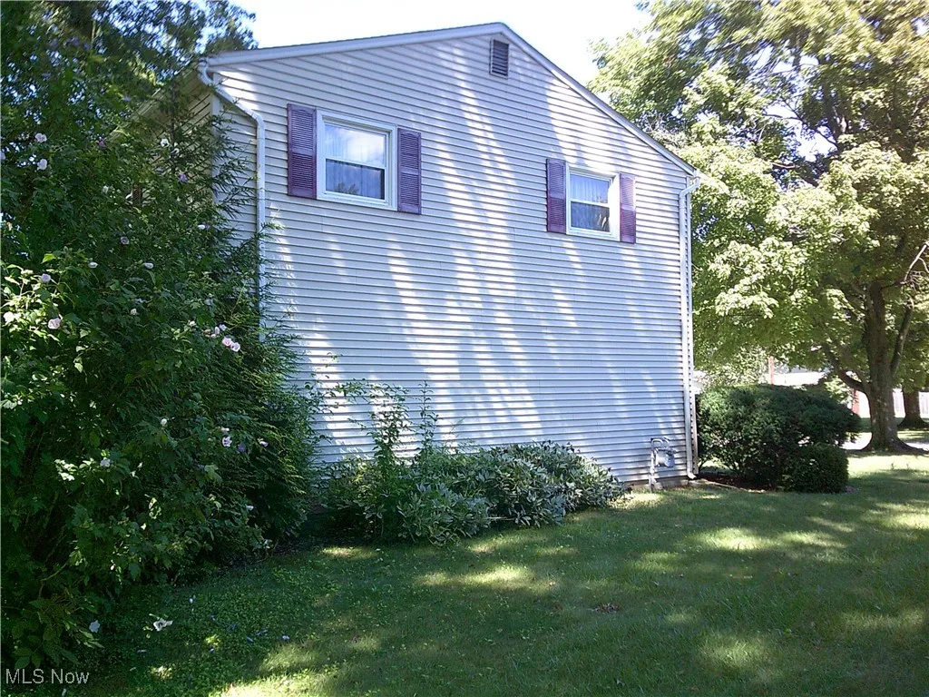 View of side of property with a yard