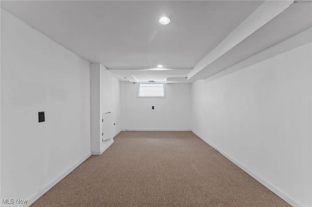Basement with light colored carpet and recessed lighting