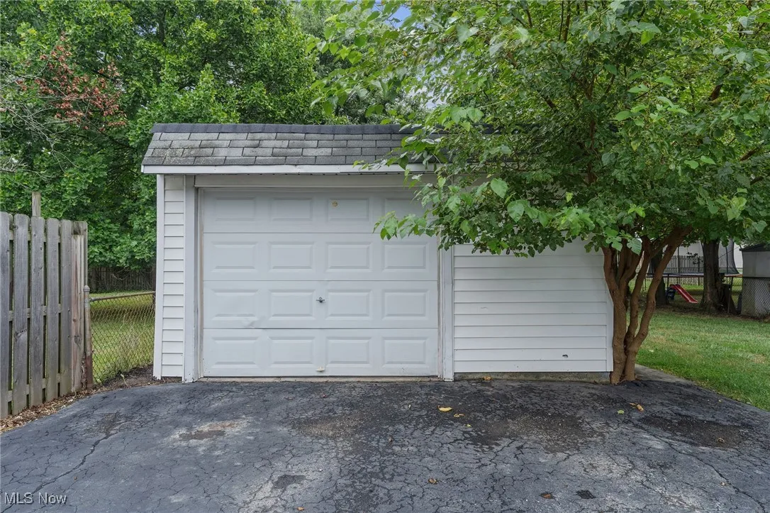 Detached garage featuring asphalt driveway