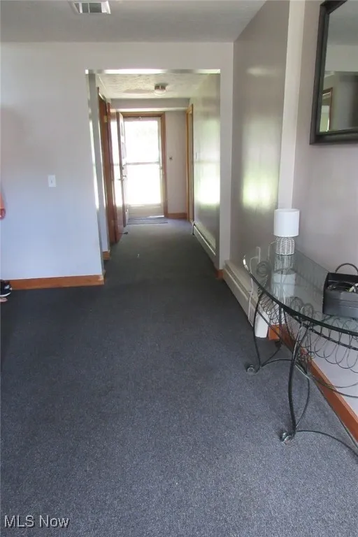 Large front entry way with closet leading to the office on right, half bath/laundry on left and the back door and attached garage too.