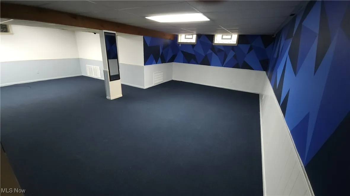 Below grade area with carpet and a paneled ceiling