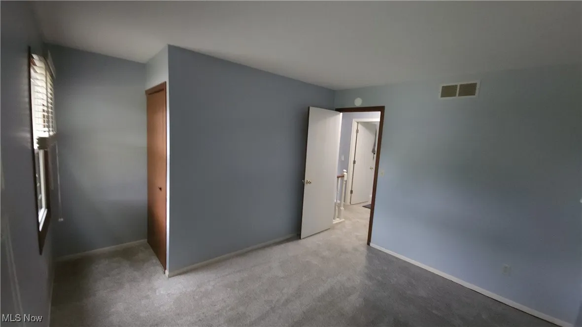 Unfurnished bedroom featuring carpet floors and a closet