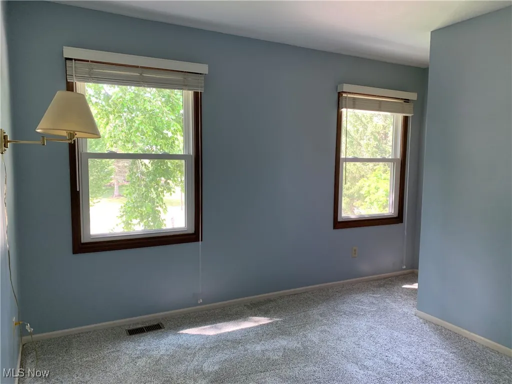 Empty room featuring carpet floors and baseboards