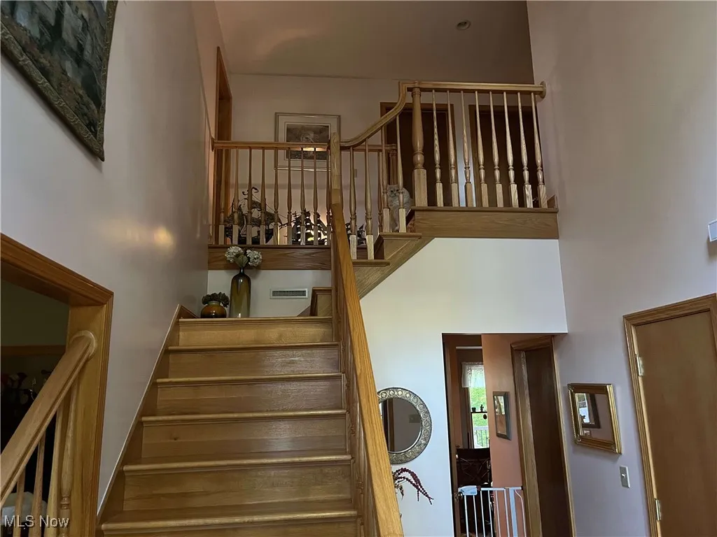 Staircase featuring a high ceiling