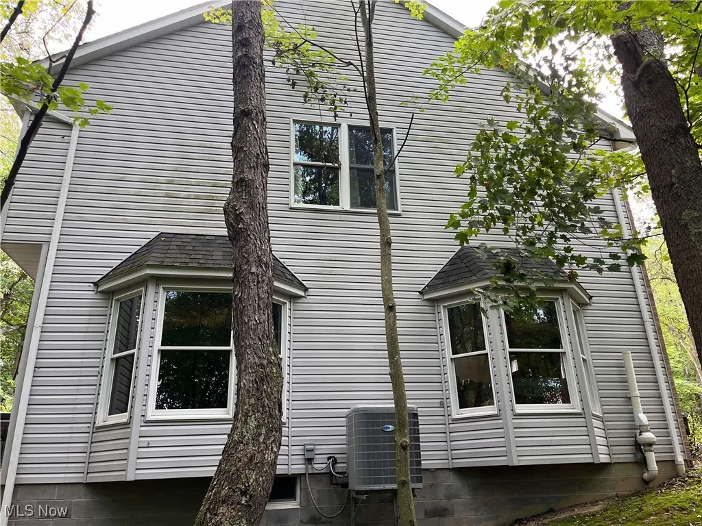 View of property exterior with a central air condition unit