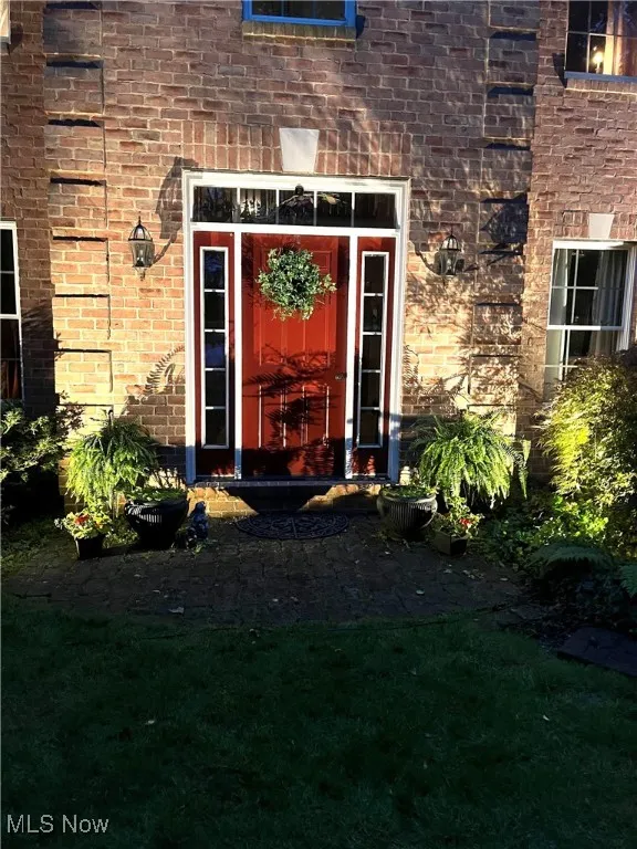 Doorway to property with brick siding