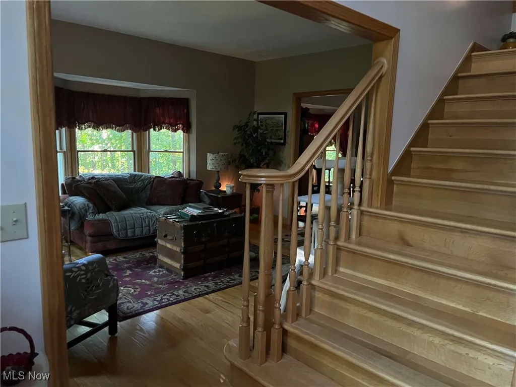 Stairs featuring wood finished floors