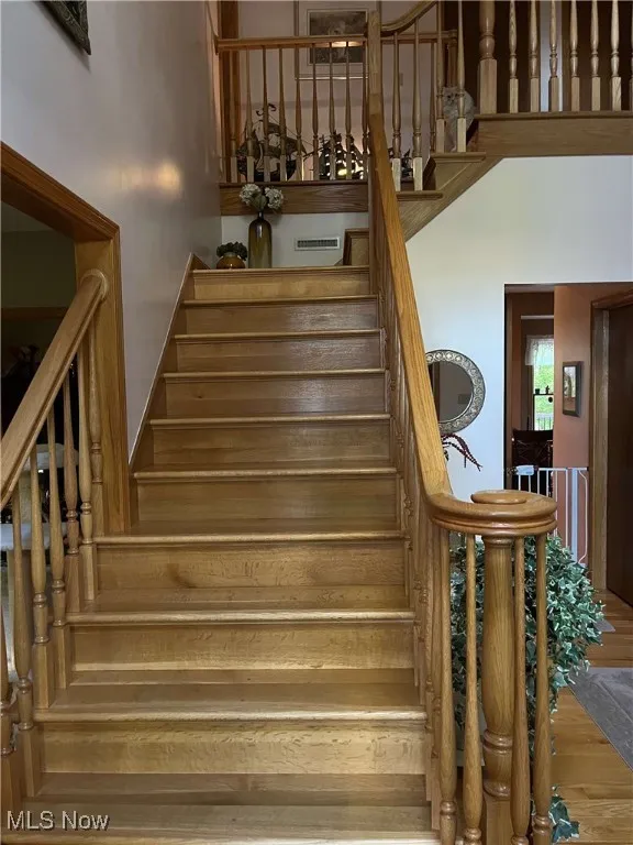 Staircase featuring wood finished floors