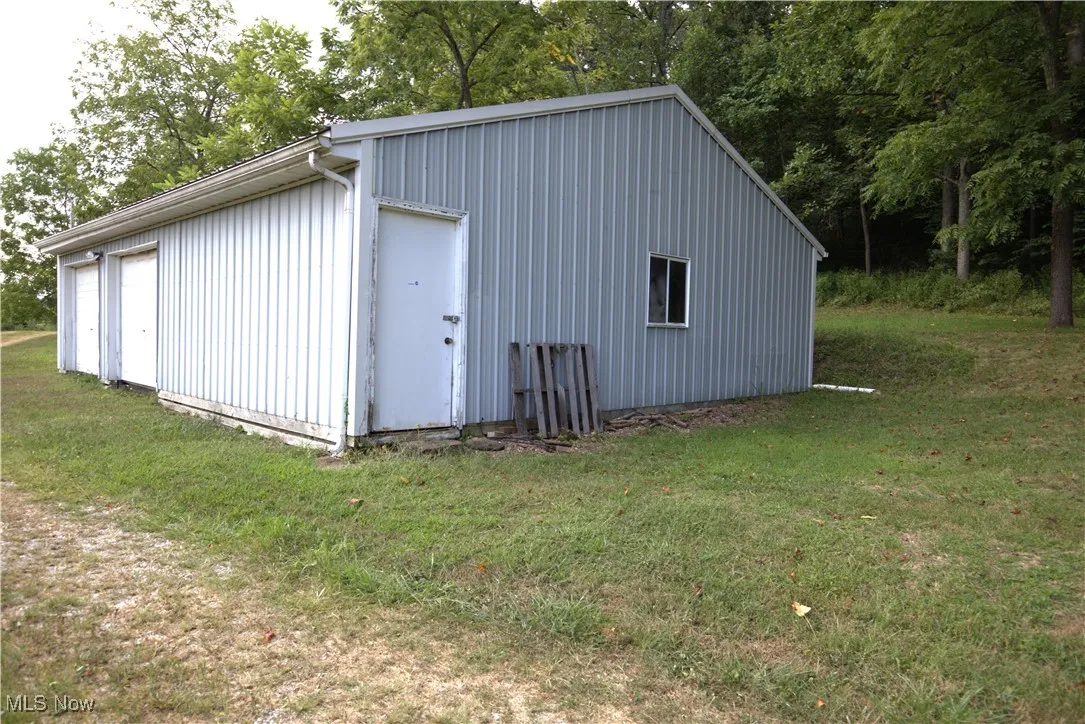 View of outbuilding with view of scattered trees