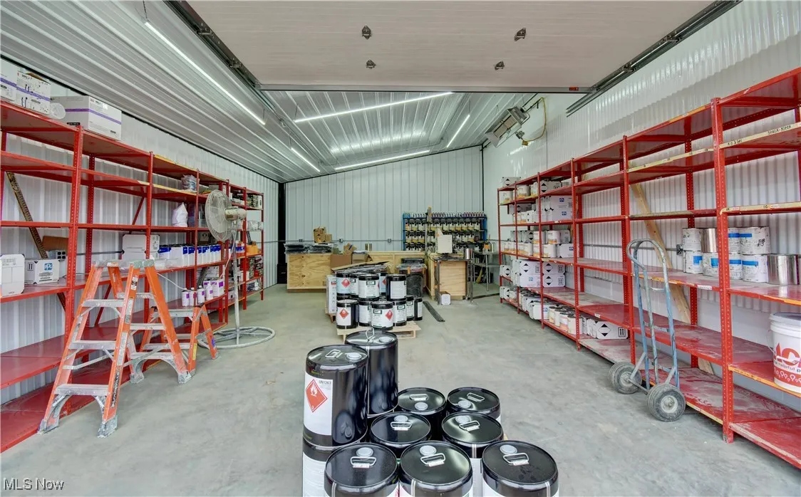 Garage featuring metal wall and a workshop area