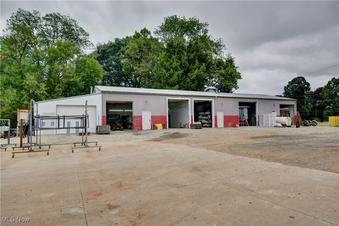 View of outbuilding featuring dirt driveway