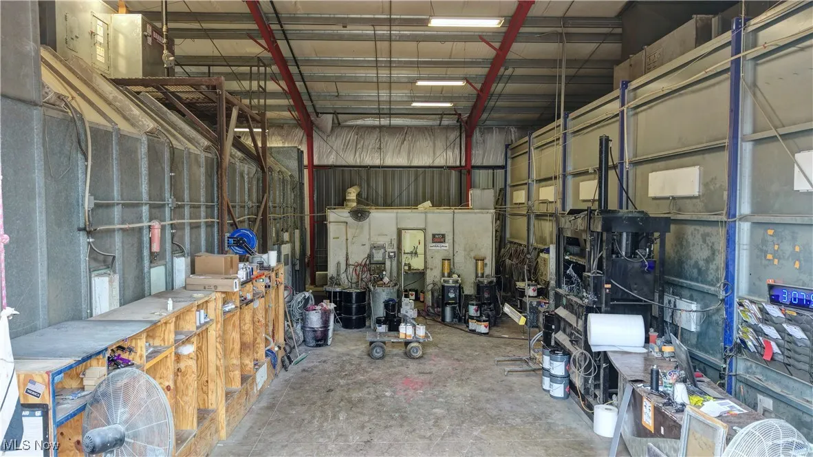 Garage featuring metal wall and a workshop area