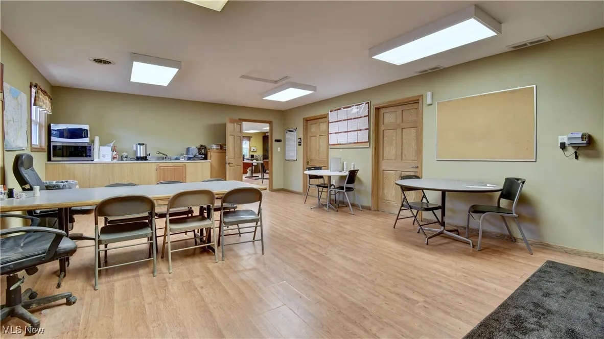 Dining space with light wood-style flooring and baseboards