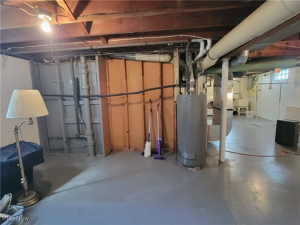Below grade area featuring water heater and a sink