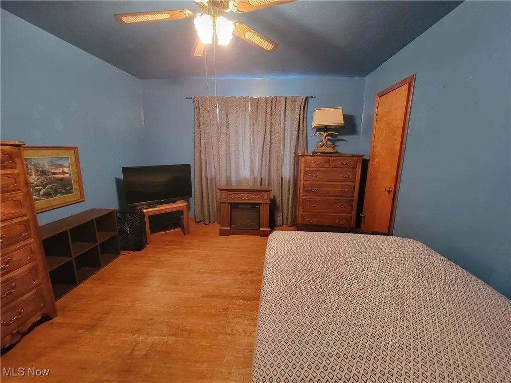 Bedroom with wood finished floors and a ceiling fan