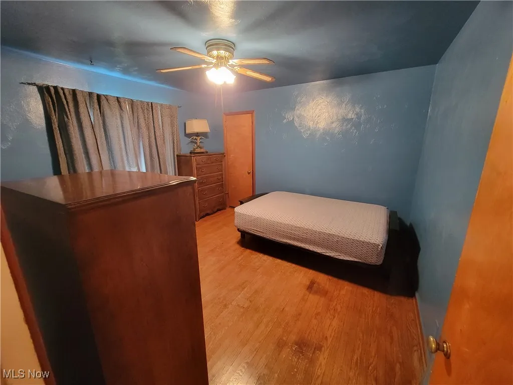 Bedroom with light wood-style flooring and ceiling fan