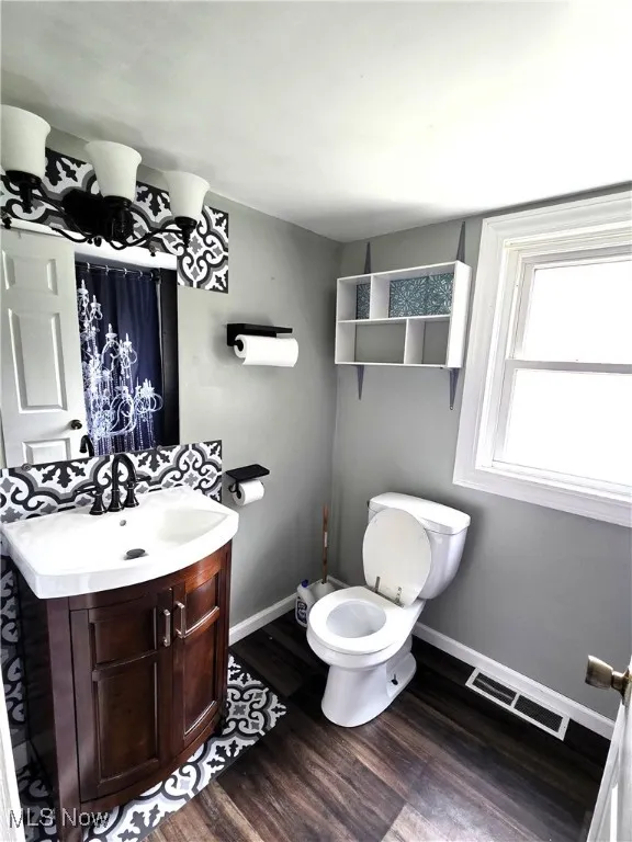 Bathroom featuring vanity and dark wood finished floors