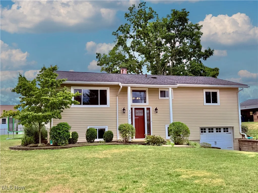 Split foyer home with a garage and a chimney
