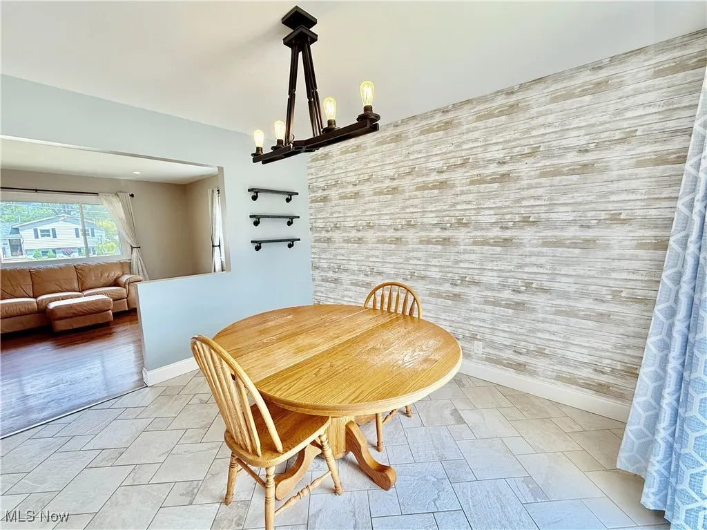 Dining space featuring a chandelier and baseboards